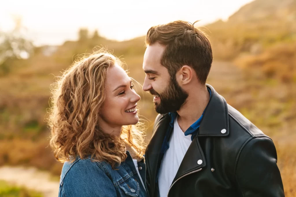 romantic couple embracing outdoors at sunset utc